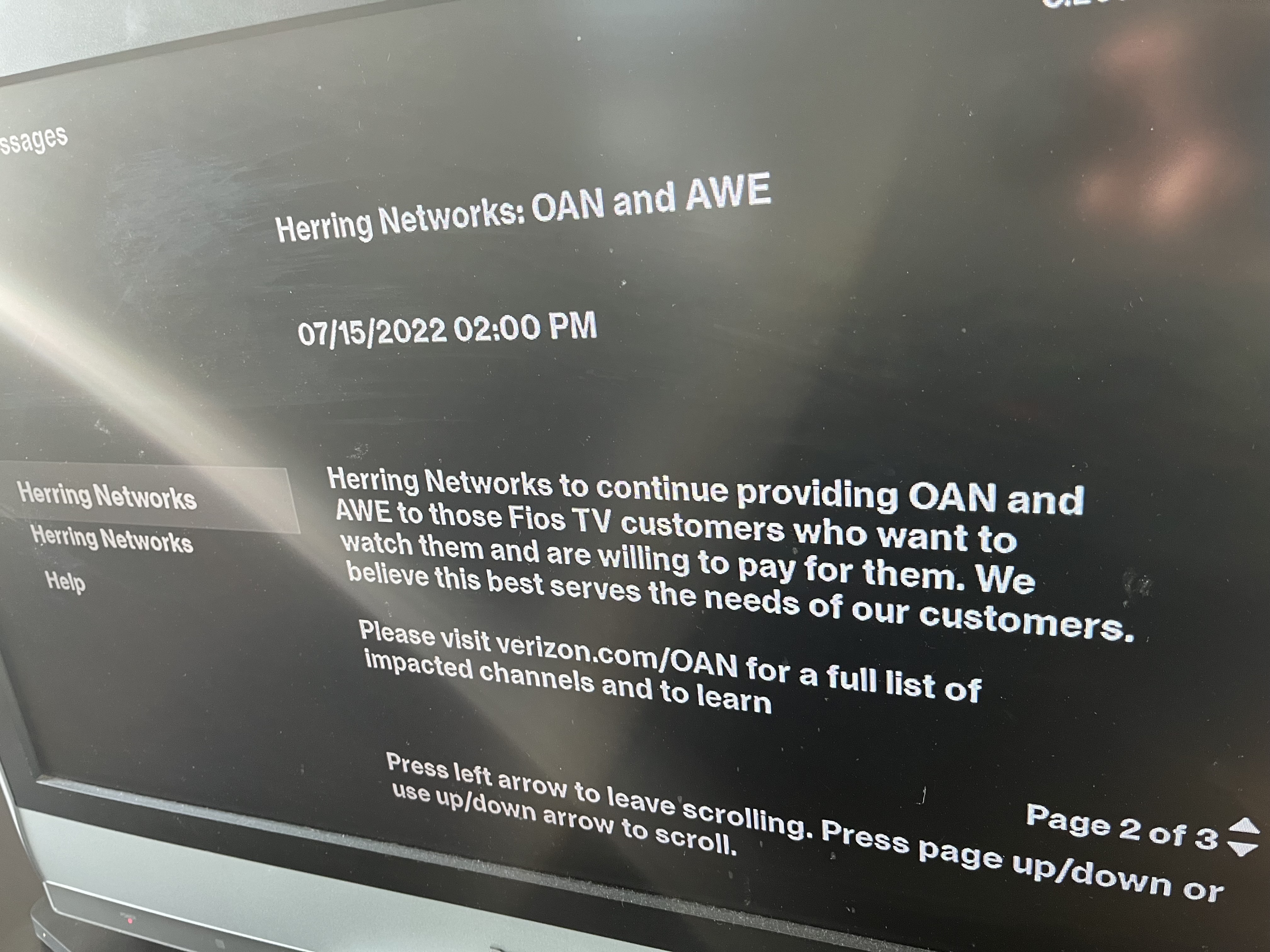 A photo of a TV displaying a message from Verizon Fios: "Herring Networks: OAN and AWE 07/15/2022 02:00 PM Herring Networks to continue providing OAN and AWE to those Fios TV customers who want to watch them and are willing to pay for them. We believe this best serves the needs of our customers."