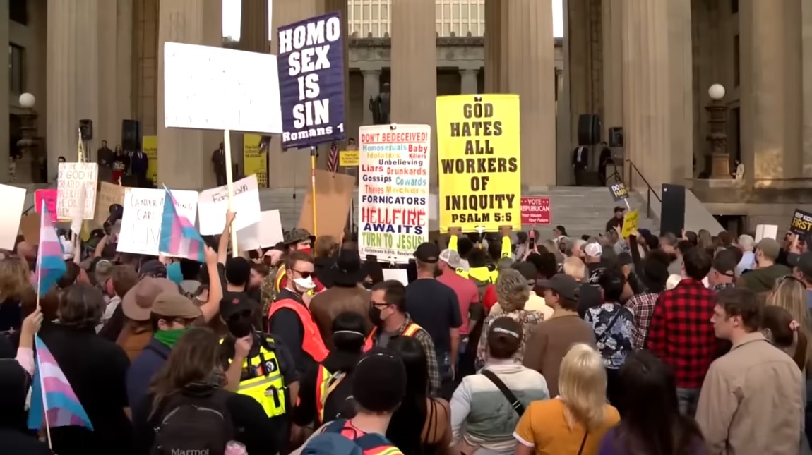 screenshot of crowd at Matt Walsh's Tennessee rally, sign reads "homo sex is sin"