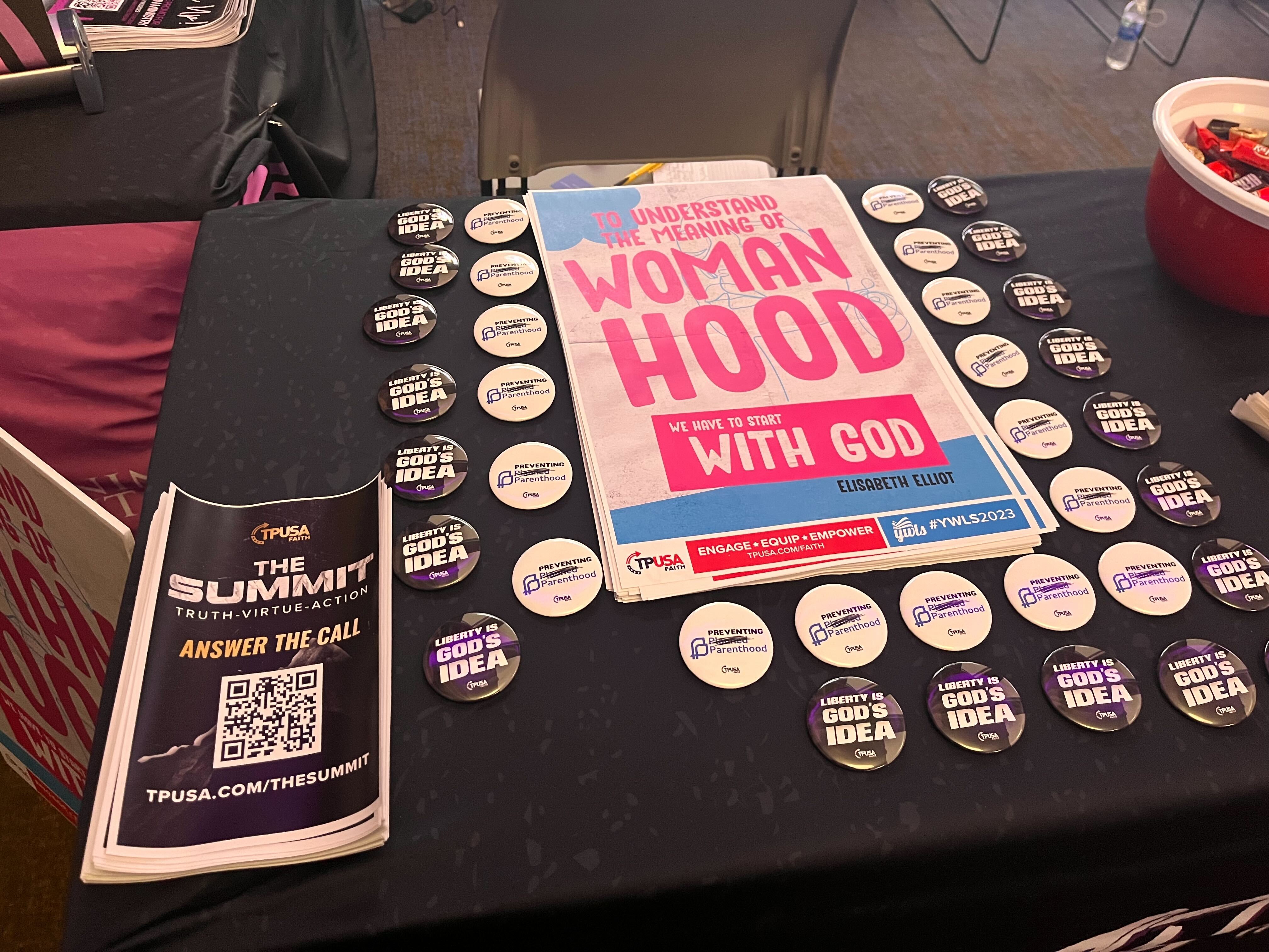 Poster reading "to understand the meaning of womanhood, we have to start with God." 