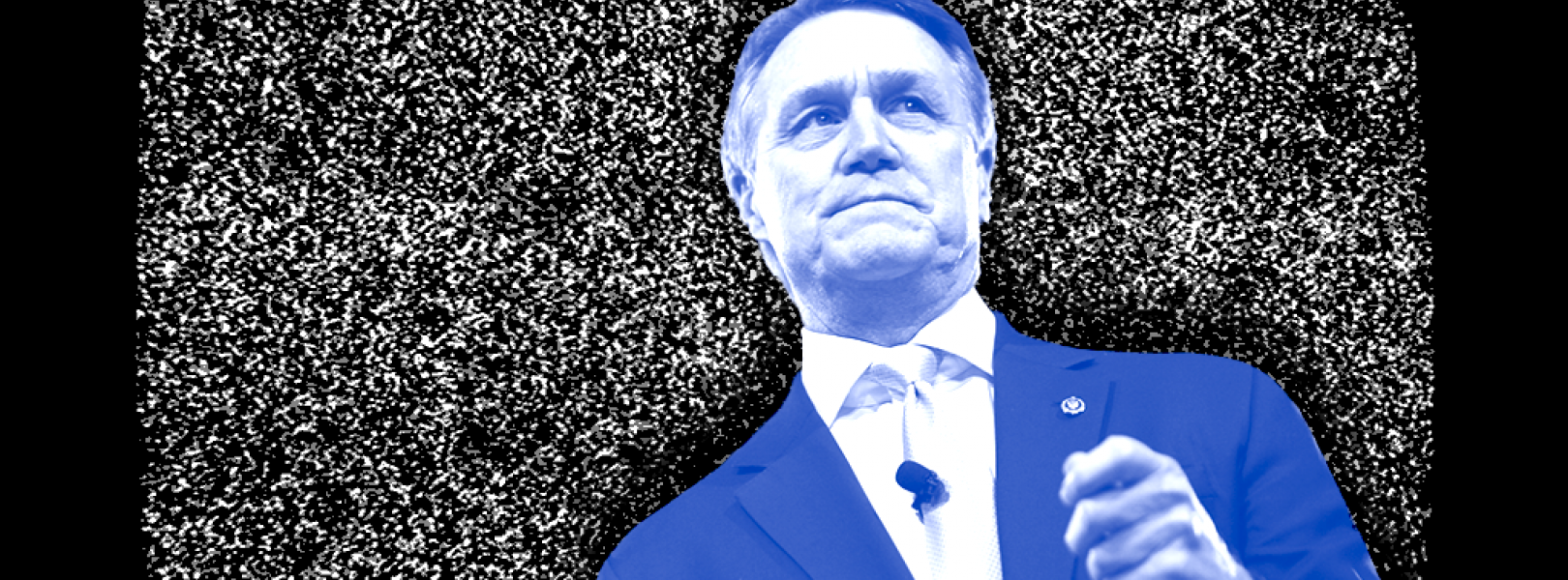 Sen. David Perdue (R-GA) in front of a TV showing static