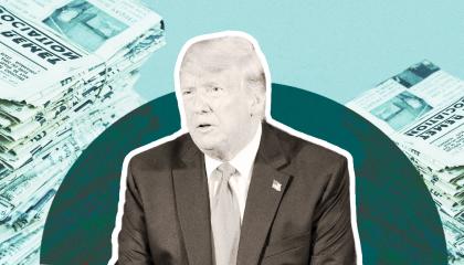 Trump sitting in front of papers