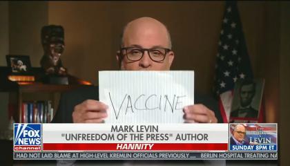 Mark Levin holds up paper in front of his face reading "VACCINE" on it, chyron reads: "Mark Levin unfreedom of the press author"