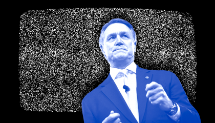 Sen. David Perdue (R-GA) in front of a TV showing static