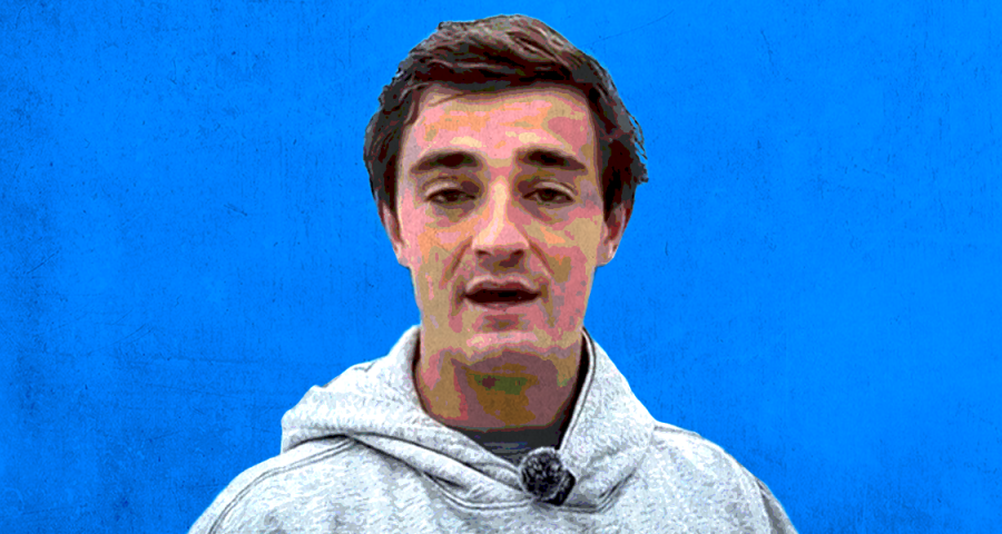nick shirley in a gray hoodie before a blue background
