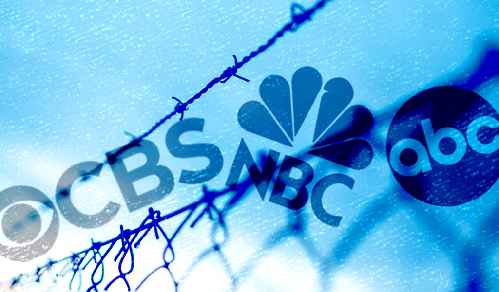 Border fence with broadcast network logos
